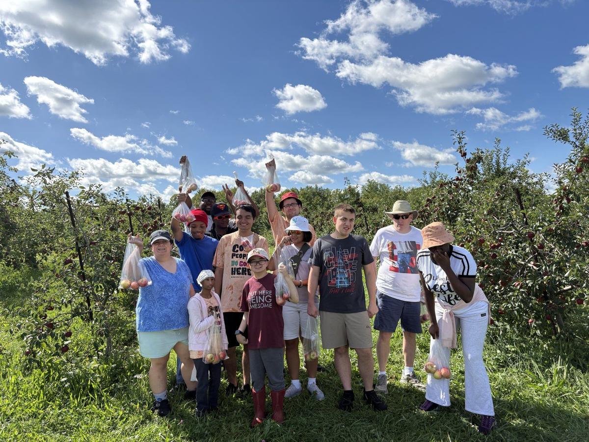 Members apple picking at an orchard