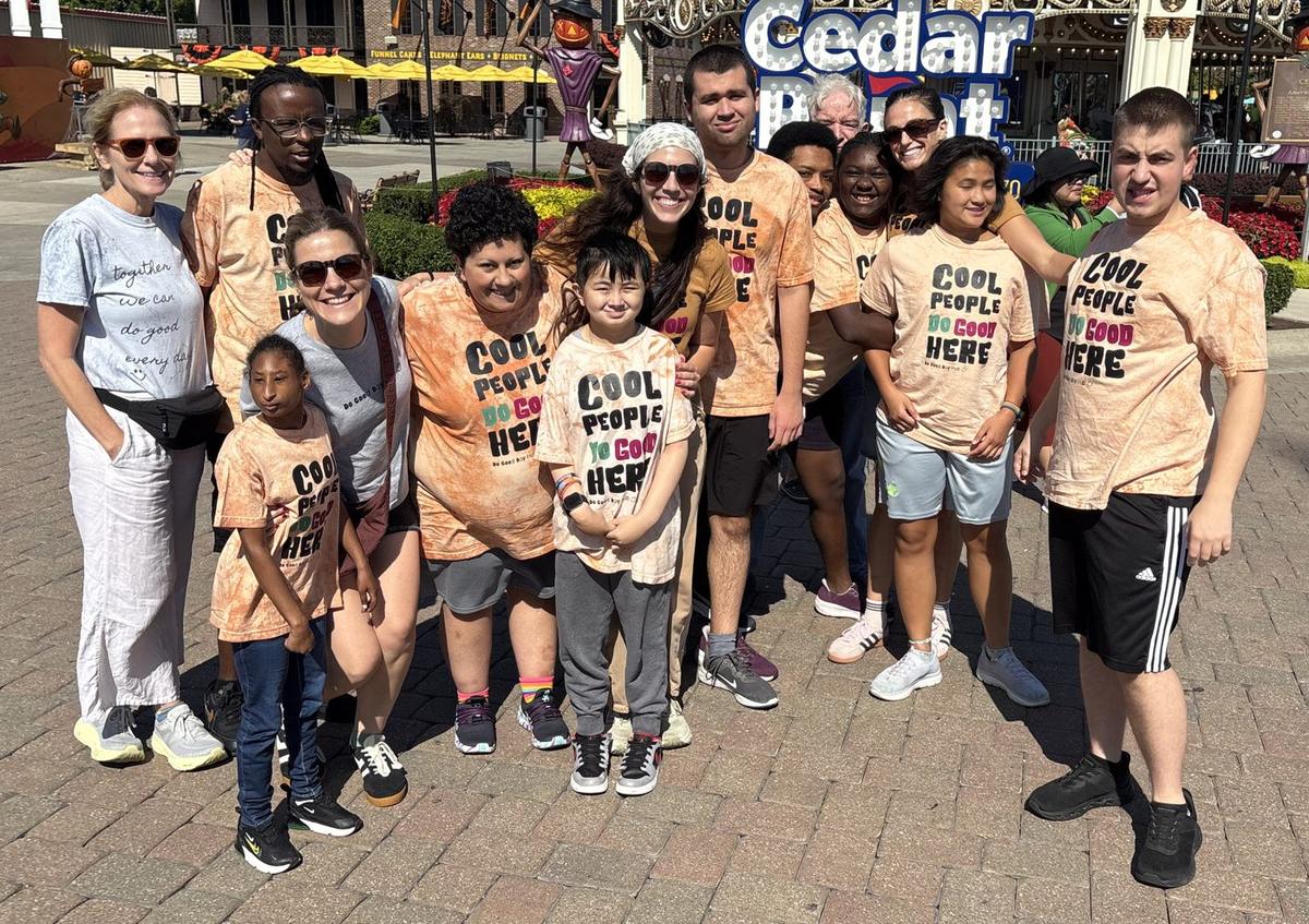 Hub members and staff in matching Cool People Do Good Here shirts on an outing